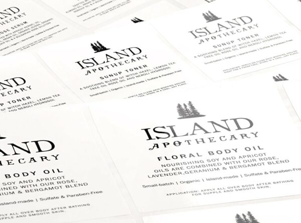 white custom lotion labels printed with black Island Apothecary label artwork