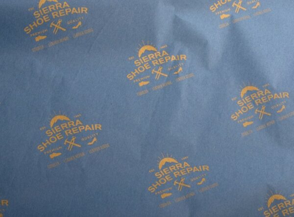 17gsm custom tissue paper with gold shoe repairlogo print 17gsm custom royal blue tissue paper with Sierra Shoe Repair logo pattern printed in gold ink