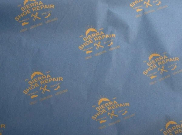 17gsm custom tissue paper with gold shoe repairlogo print 17gsm custom royal blue tissue paper with Sierra Shoe Repair logo pattern printed in gold ink