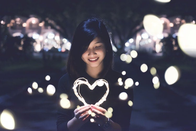 Person holding a heart - Aim for happy customers