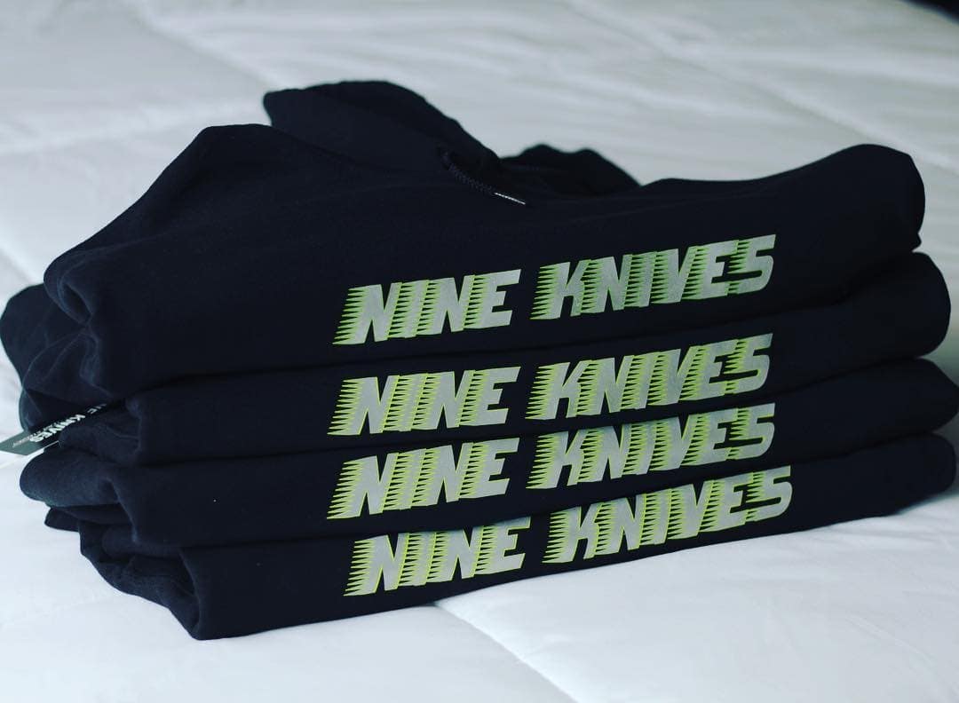 Nine Knives - Reflective Hoodie Folded Pile - Inkable Label Co. Spotlight