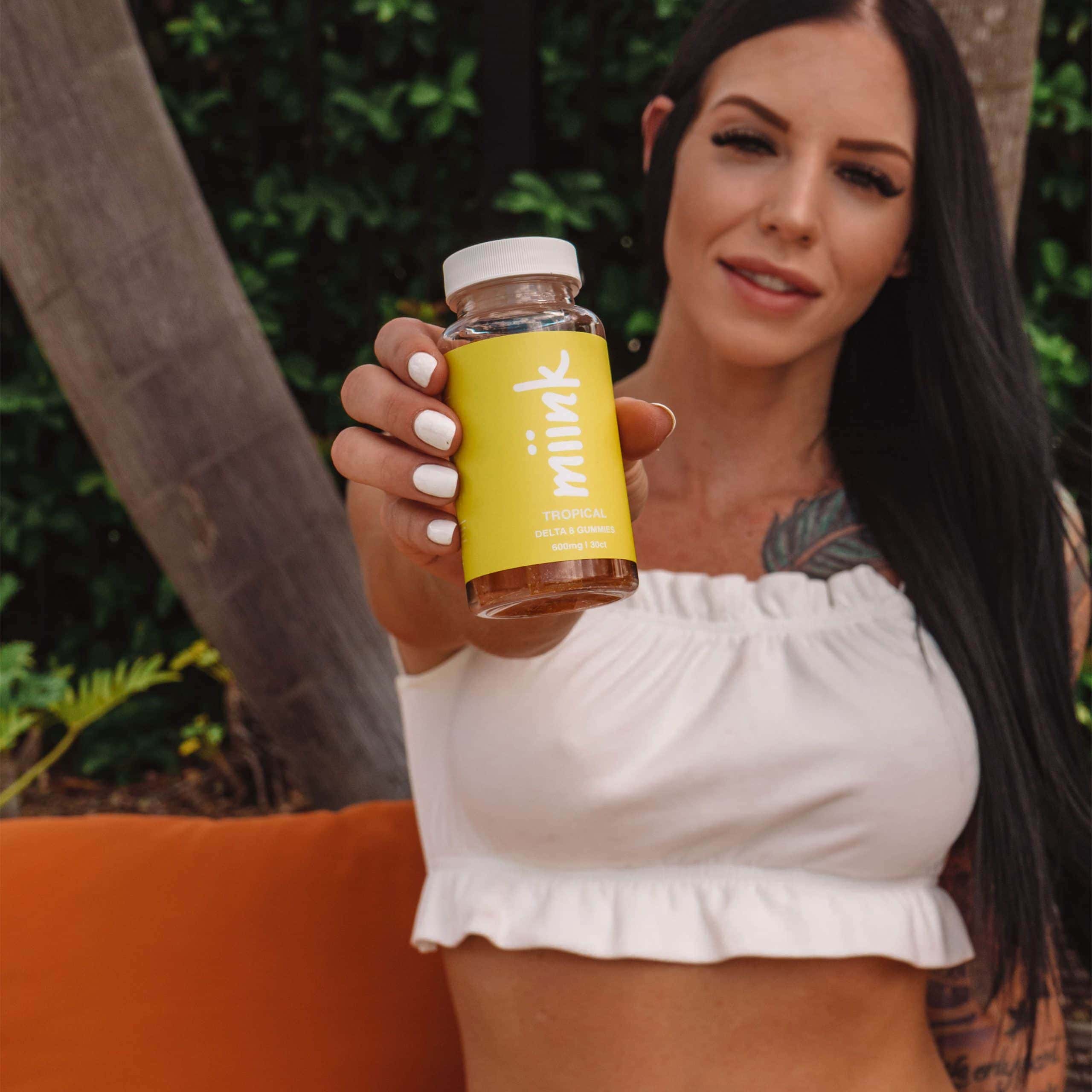 Woman holding Miink tropical gummies